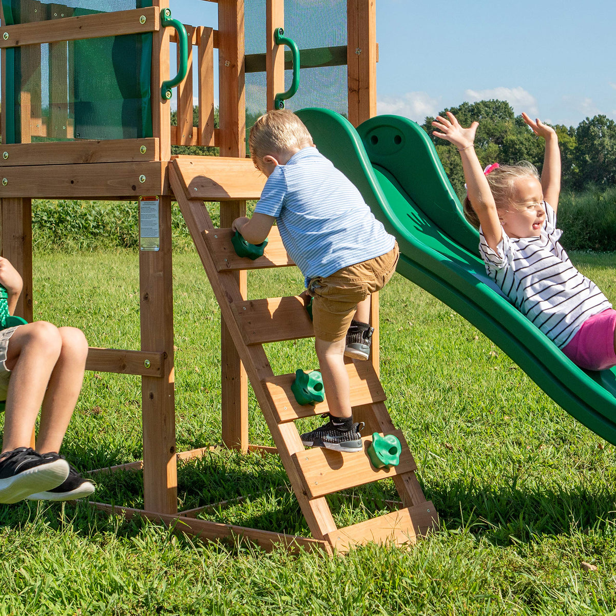Backyard Discovery Buckley Hill Cedar Wood Swing Set with Wave Slide, Play Deck, Rock Wall Ladder, Belt Swings, Chalkboard, Canopy Roof, Outdoor Playset